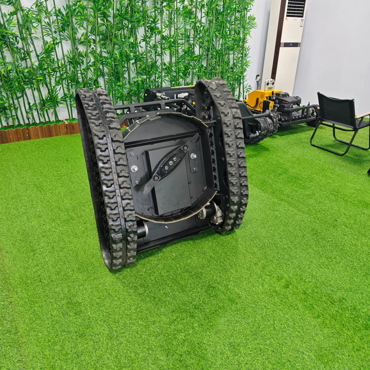 Robotic vehicle with large wheels on a green artificial grass surface