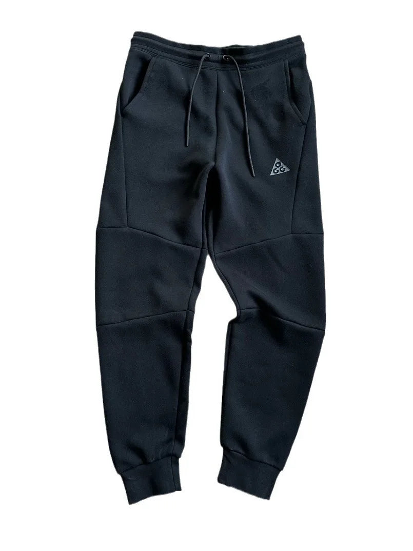 Black sweatpants with a logo on a white background