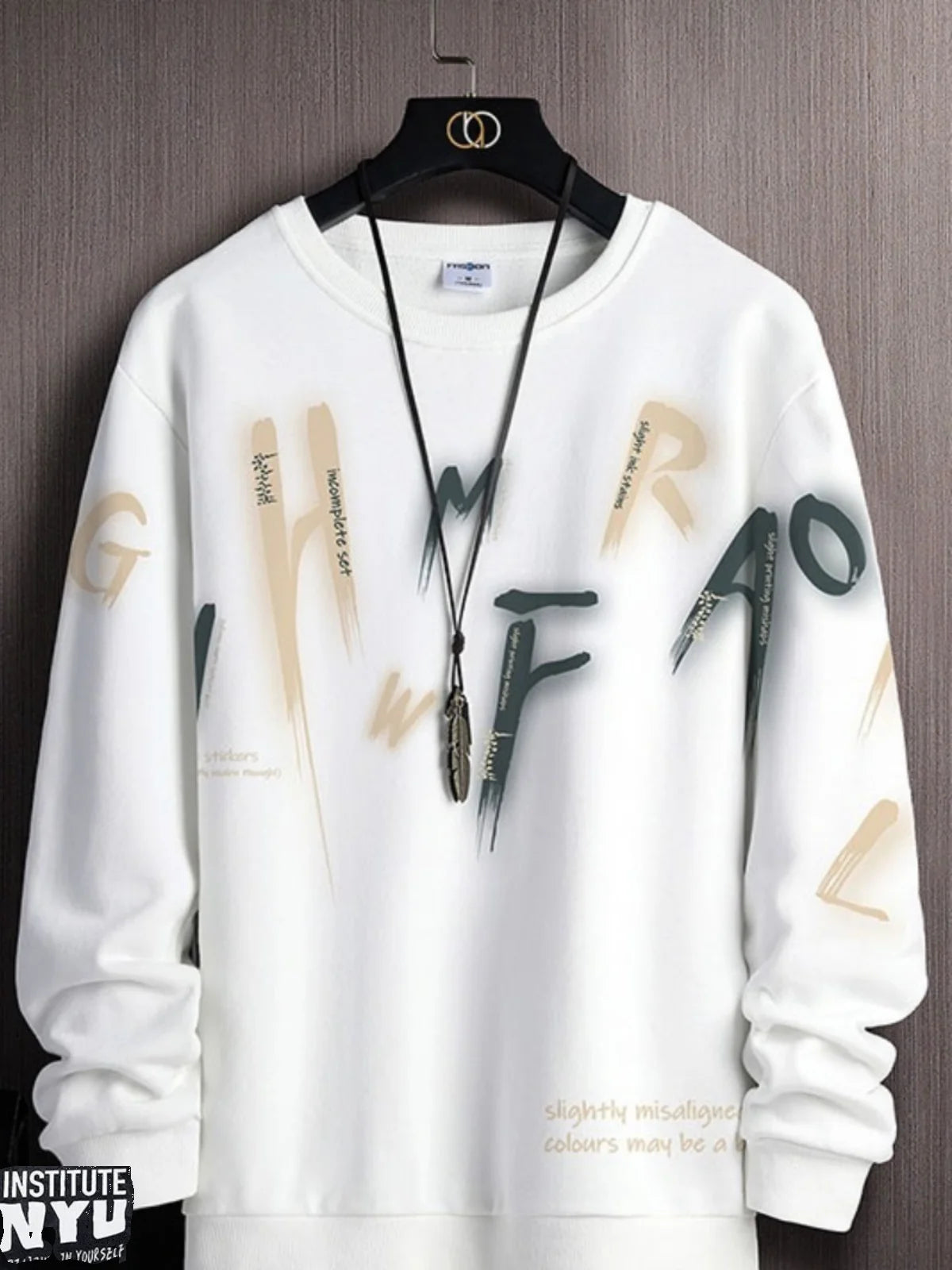 White sweatshirt with colorful lettering on a hanger against a gray background