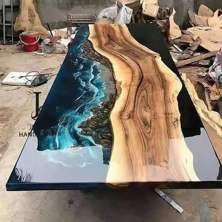 Wooden table with blue resin design in a workshop setting