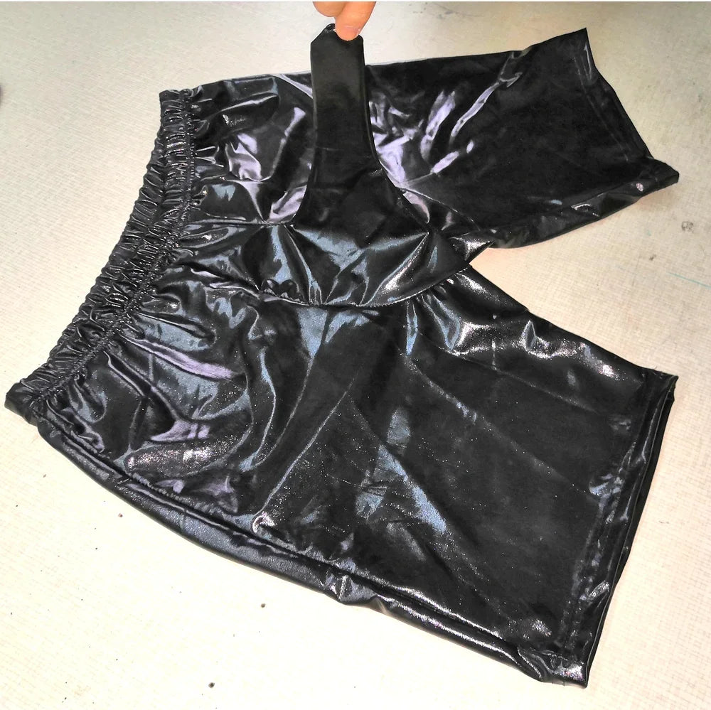 Black shiny pants on a light gray background