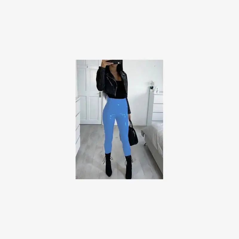 Person wearing blue leggings and black jacket in a room.