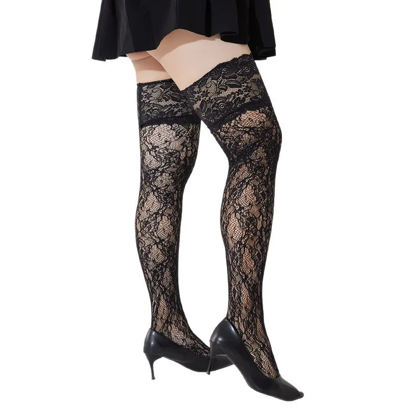 Black lace thigh-high stockings worn with black high heels on a white background