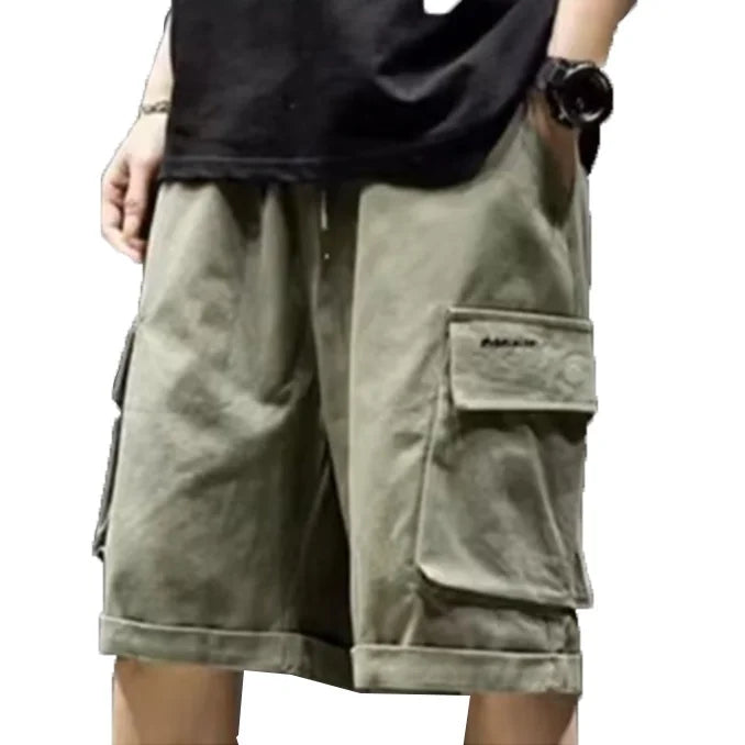 Khaki cargo shorts worn by a person on a white background