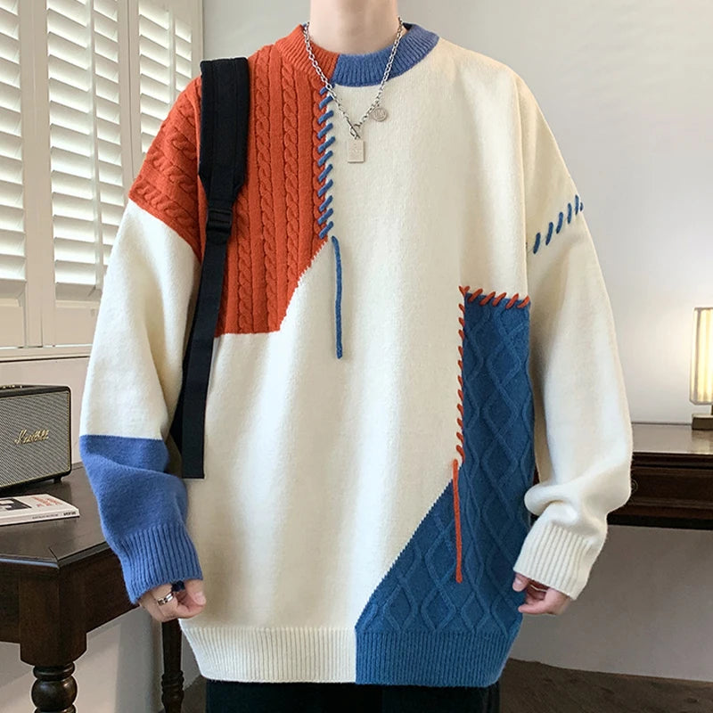 Person wearing a colorful sweater with geometric pattern in a room.