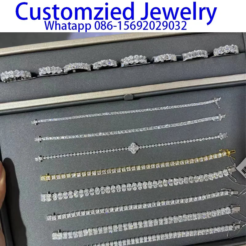Collection of silver jewelry on a display card with contact information.