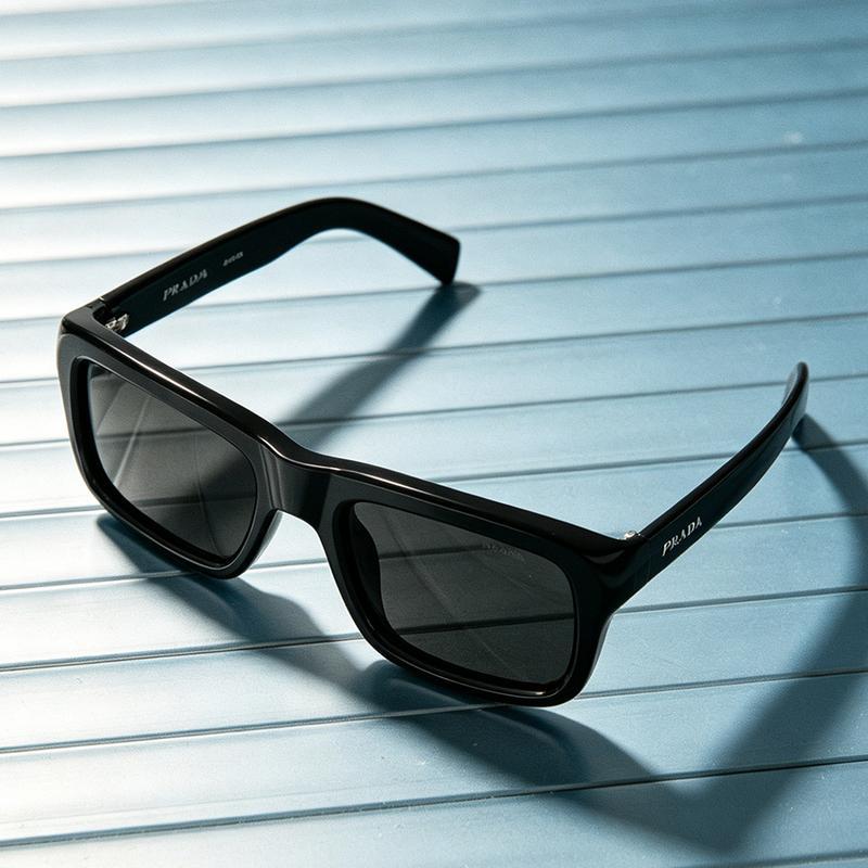 Prada 0PR D11SF black acetate square sunglasses on magazine