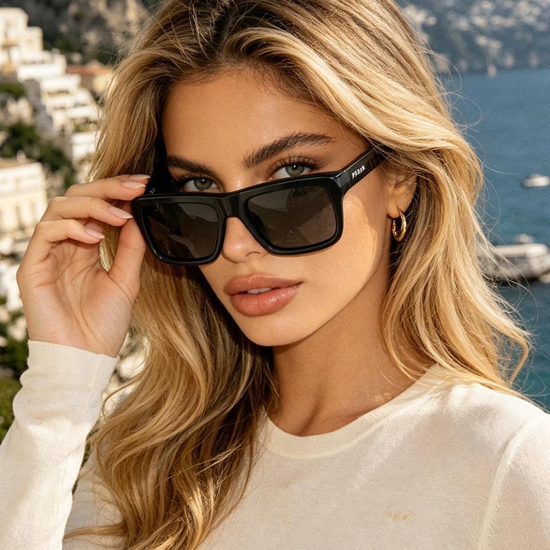 Dark-haired woman wearing Prada 0PR D11SF sunglasses by window