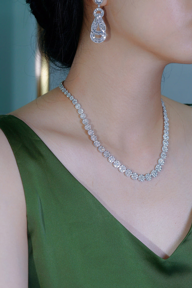 18K White Gold Natural Diamond Cluster Necklace laid flat on leather surface