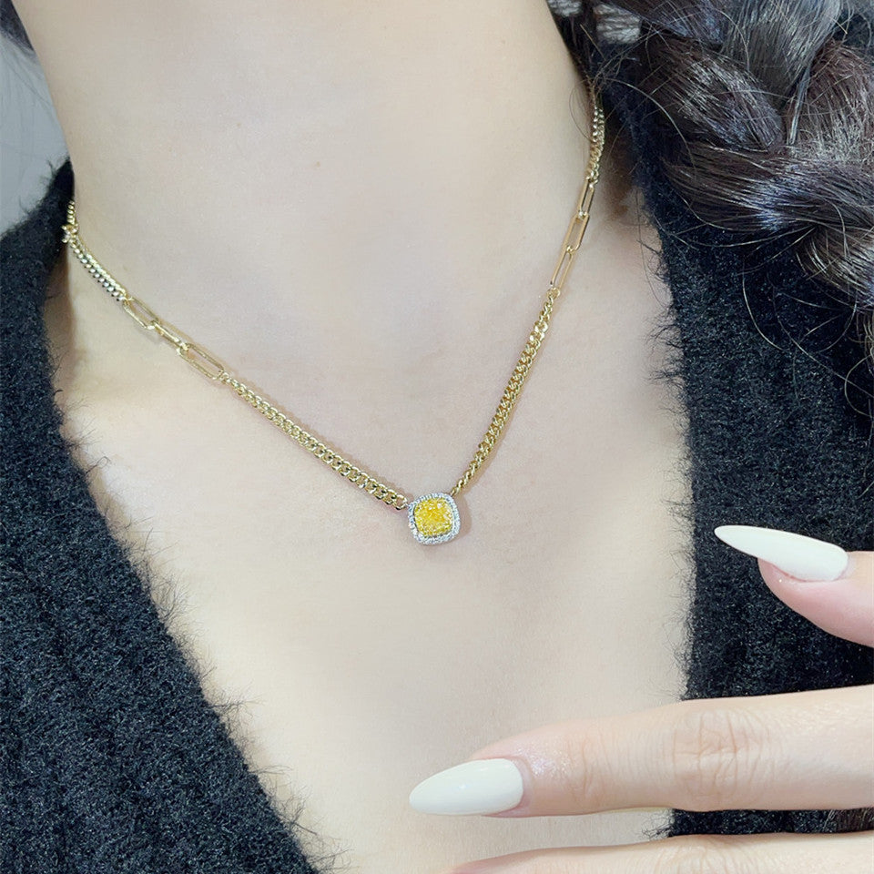 18K yellow gold Cuban link necklace with yellow diamond pendant worn on neck