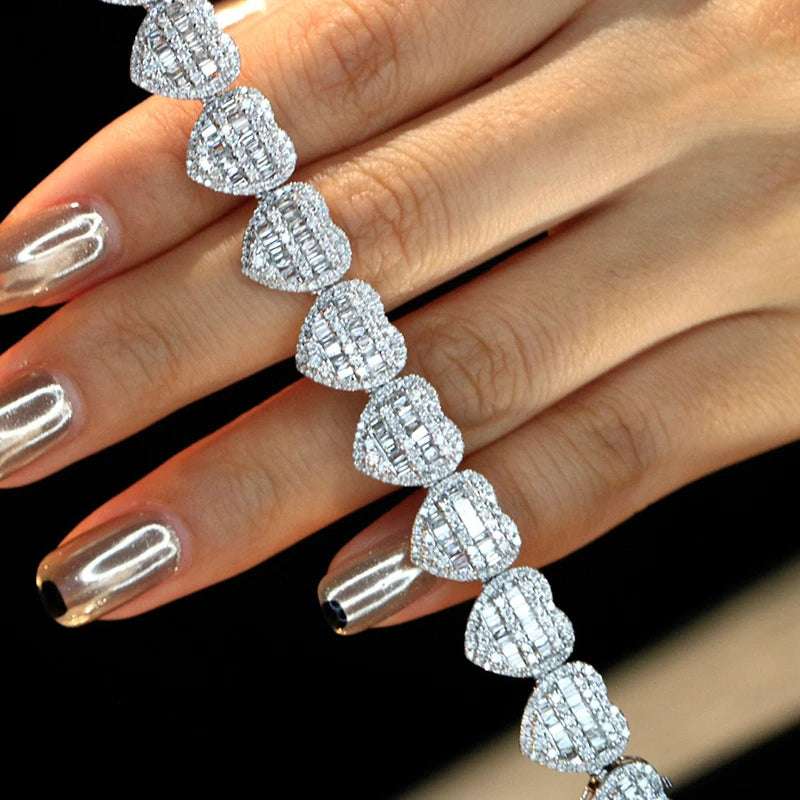 18K White Gold Heart Baguette Diamond Bracelet held in hands