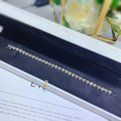 Silver bracelet with gemstones in a jewelry box with floral background