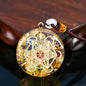Decorative pendant with geometric design on a reflective surface