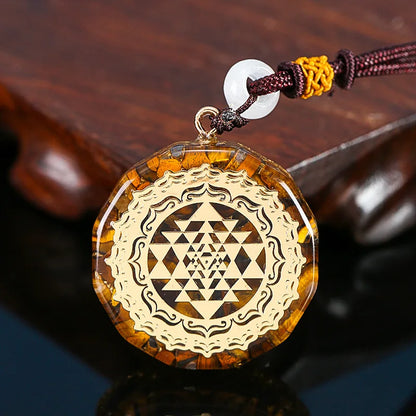 Decorative pendant with intricate design on a wooden surface