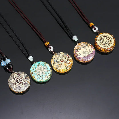 Set of five decorative pendants on black strings against a dark background