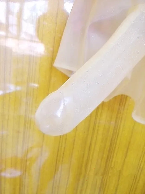 Close-up of a white plastic object on a yellow textured surface