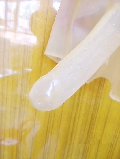 Close-up of a white plastic object on a yellow textured surface