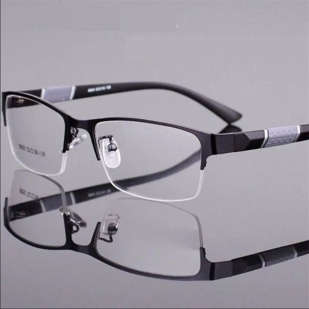 Black eyeglasses on a reflective gray surface