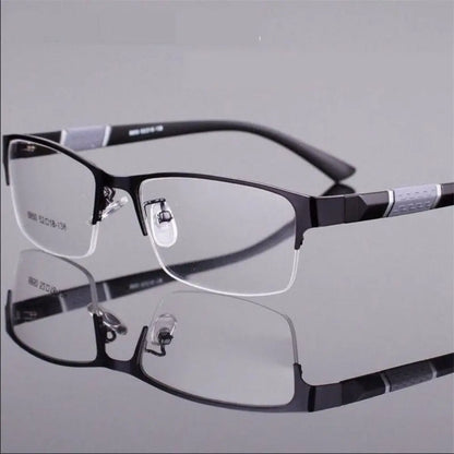 Black eyeglasses on a reflective gray surface