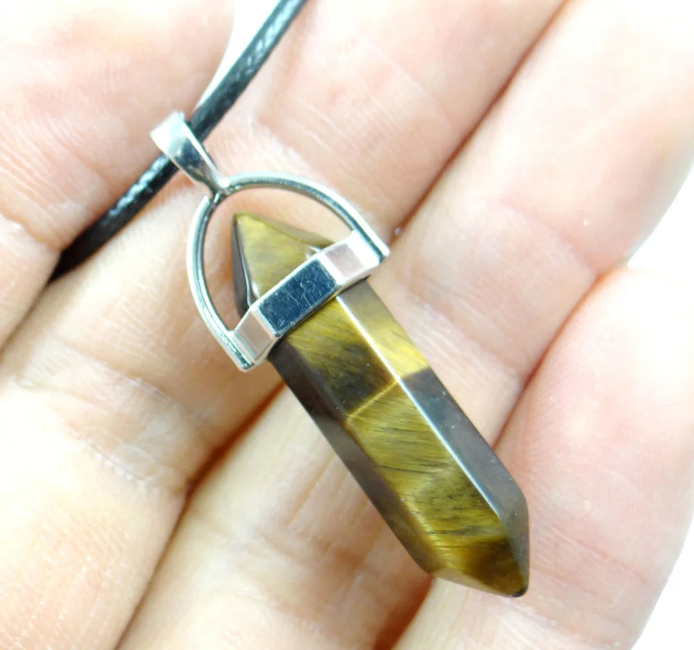Tiger eye pendant on a silver chain held between fingers