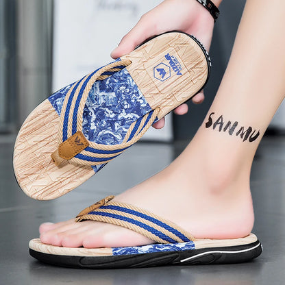 Person wearing blue and brown sandals with a visible brand logo, holding one sandal.