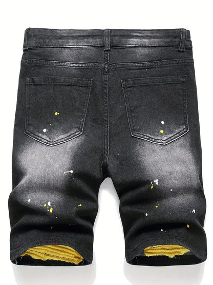 Black distressed jeans with yellow accents on a white background