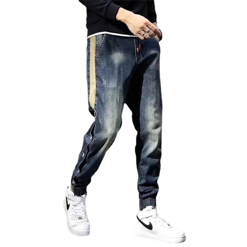 Person wearing blue jeans with a white background