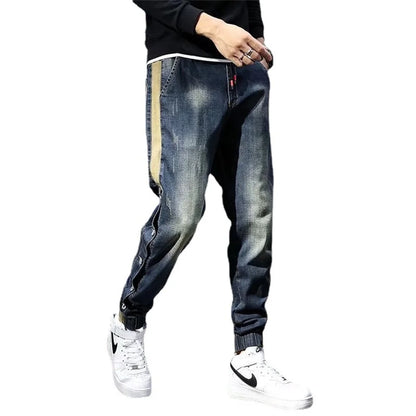 Person wearing blue jeans with a white background