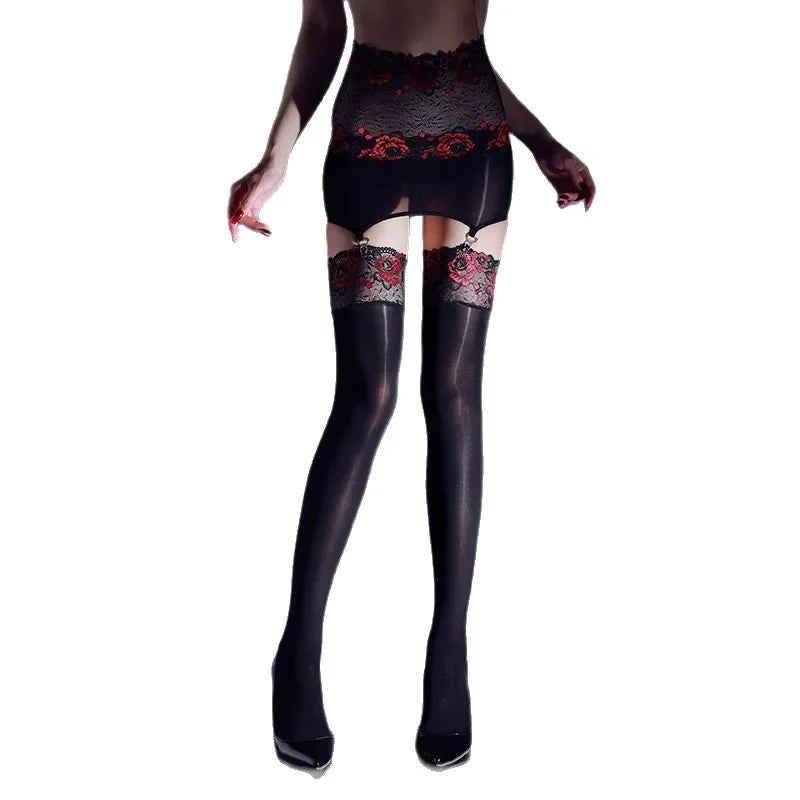 Black lace stockings with red floral patterns worn by a model on a white background