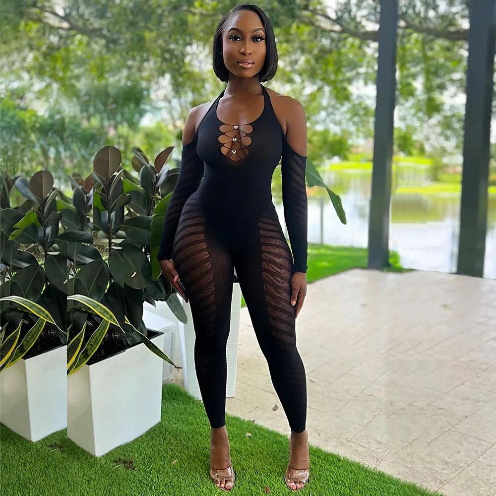 Woman wearing a black outfit with sheer panels in an outdoor setting