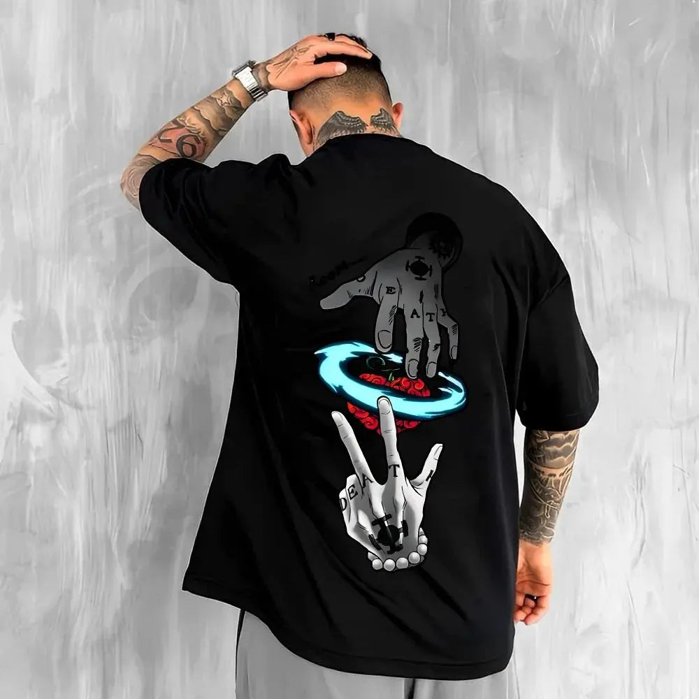 Person wearing a black t-shirt with graphic designs on the back against a gray background