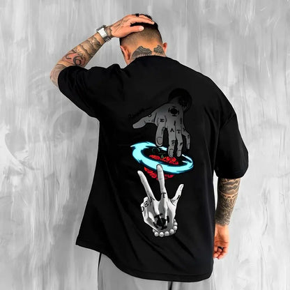 Person wearing a black t-shirt with graphic designs on the back against a gray background