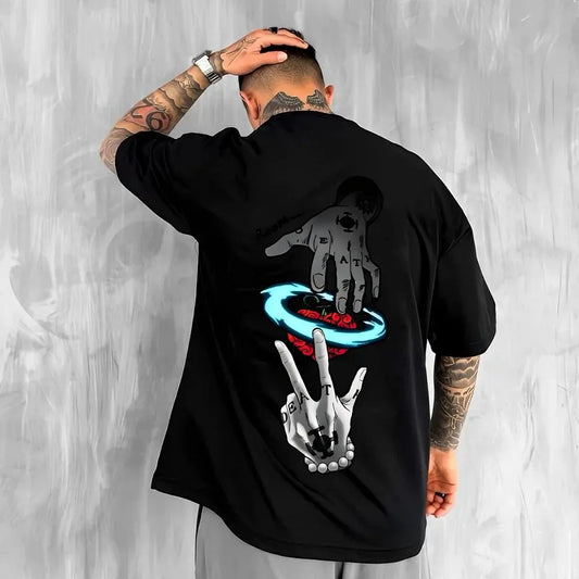 Person wearing a black t-shirt with graphic designs on the back against a gray background