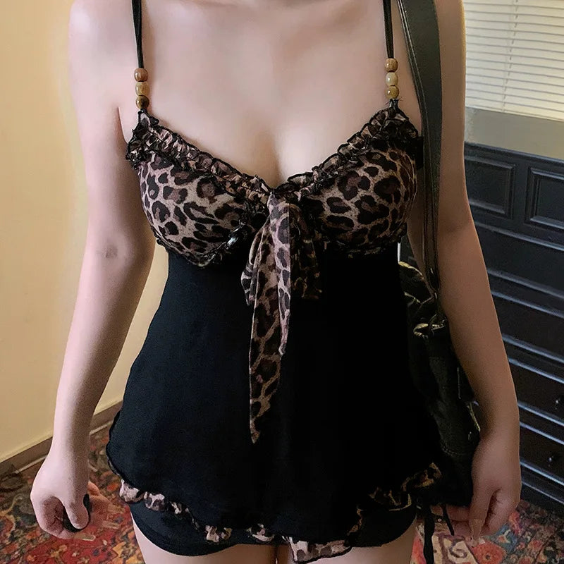 Person wearing a leopard print top and black shorts with a blurred background