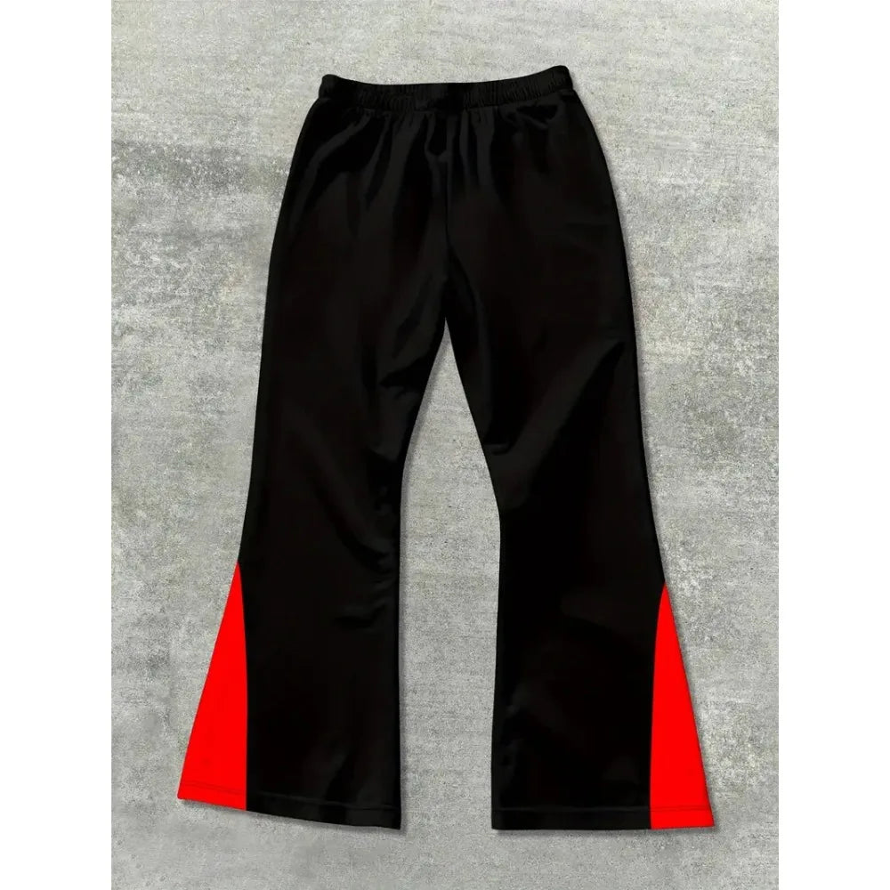 Black pants with red accents on a gray surface