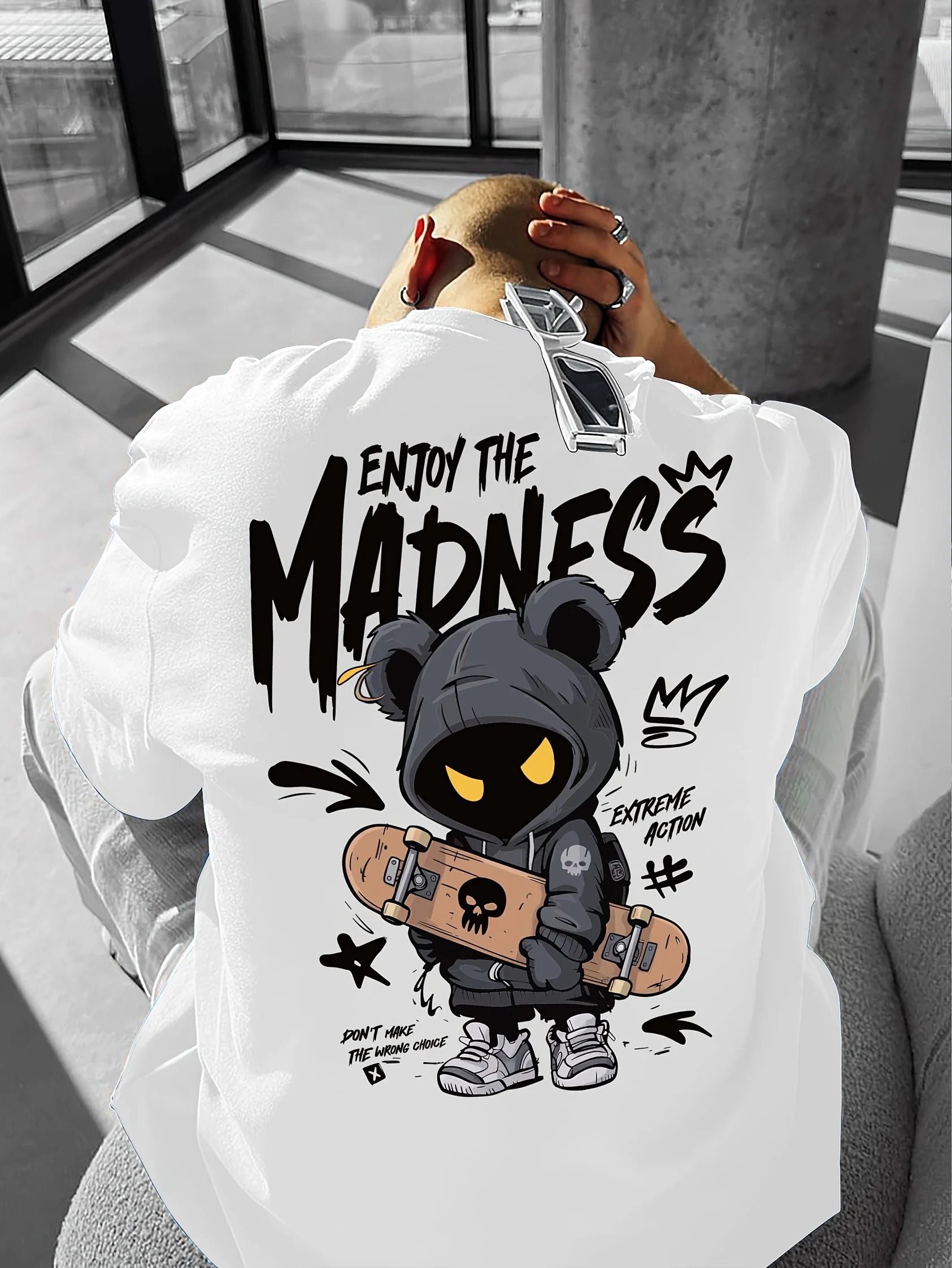 Person wearing a white hoodie with a graphic design and text.