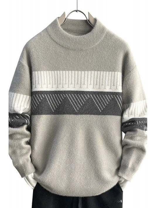 Gray sweater with geometric pattern on a hanger against a white background