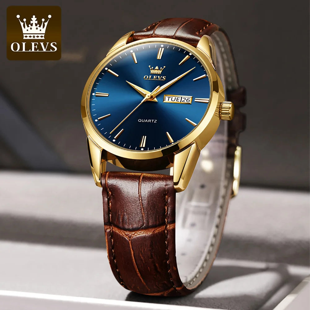 Gold watch with a blue face and brown leather strap on a gray surface, featuring the OLEVS brand.