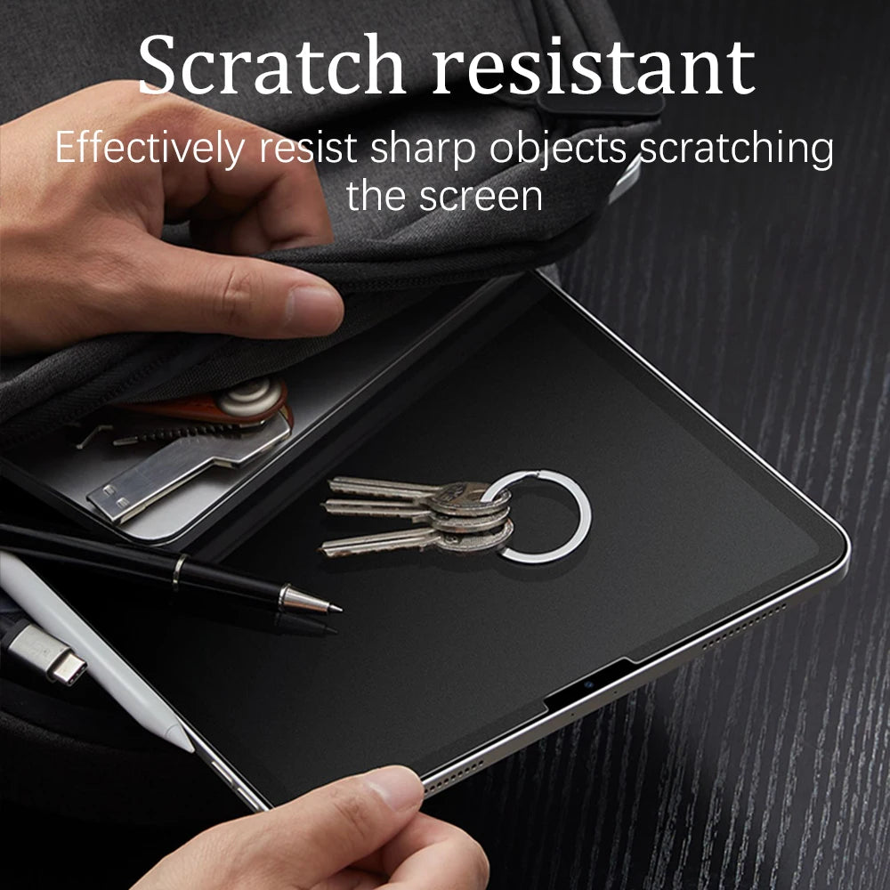 Person holding a tablet with a screen protector, showing resistance to scratches.