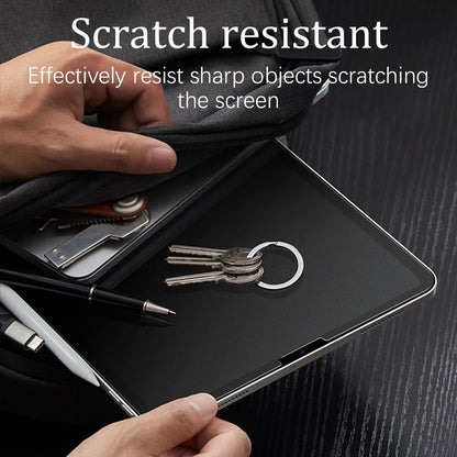 Person holding a tablet with a screen protector, showing resistance to scratches.