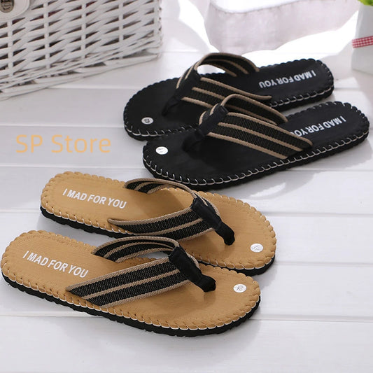 Pair of black and brown sandals with 'I MAD FOR YOU' text on a white surface.