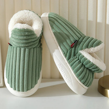 Green slippers with white fur lining on a light background