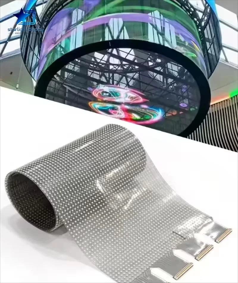 Roll of transparent material with a large curved LED display in the background
