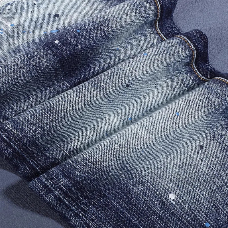 Close-up of blue denim fabric with visible texture and color variations.