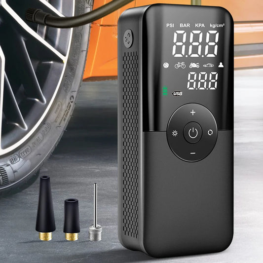 Black digital air compressor with tire and nozzle attachments on a concrete surface.