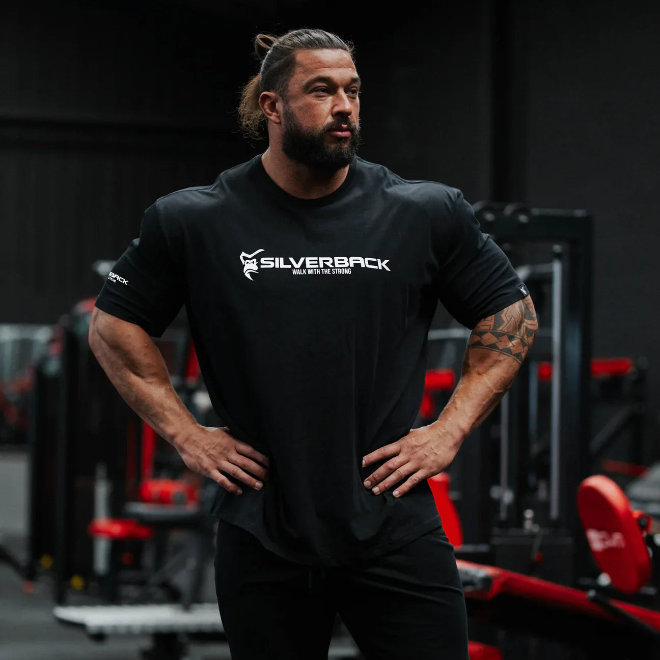 Man wearing a black 'Silverback' t-shirt in a gym setting