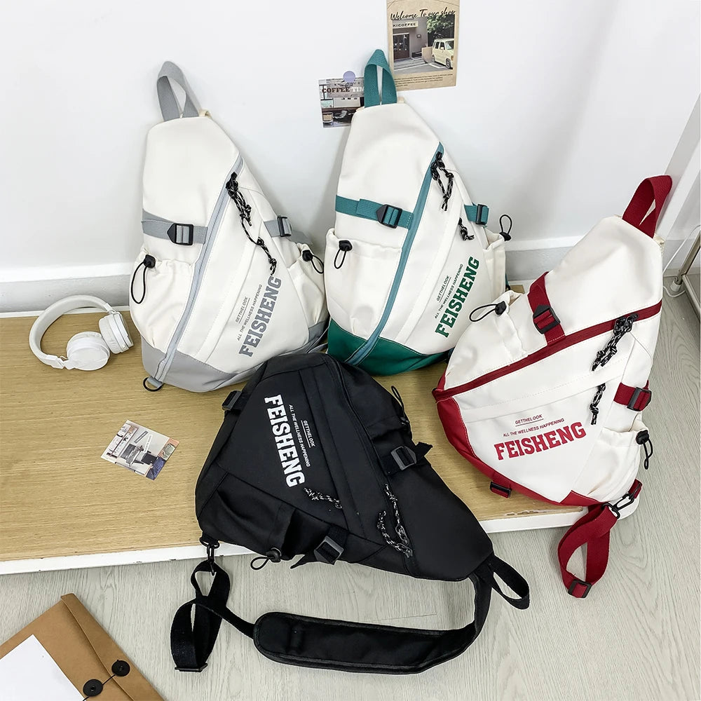 Four backpacks with 'FEISHENG' branding on a desk.