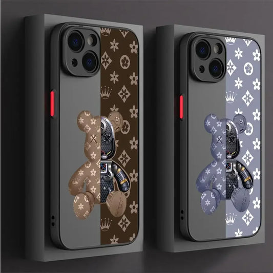Two phone cases with teddy bear and butterfly designs on a dark background