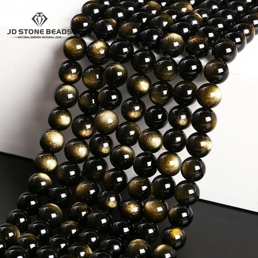 String of black and gold beads with 'JD Stone Beads' branding.