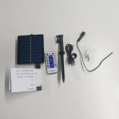 Collection of electronic components including a solar panel, remote control, and cables on a white background
